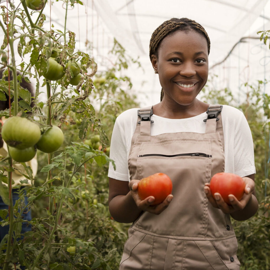 front-view-smiley-woman-taking-care-harvest-scaled